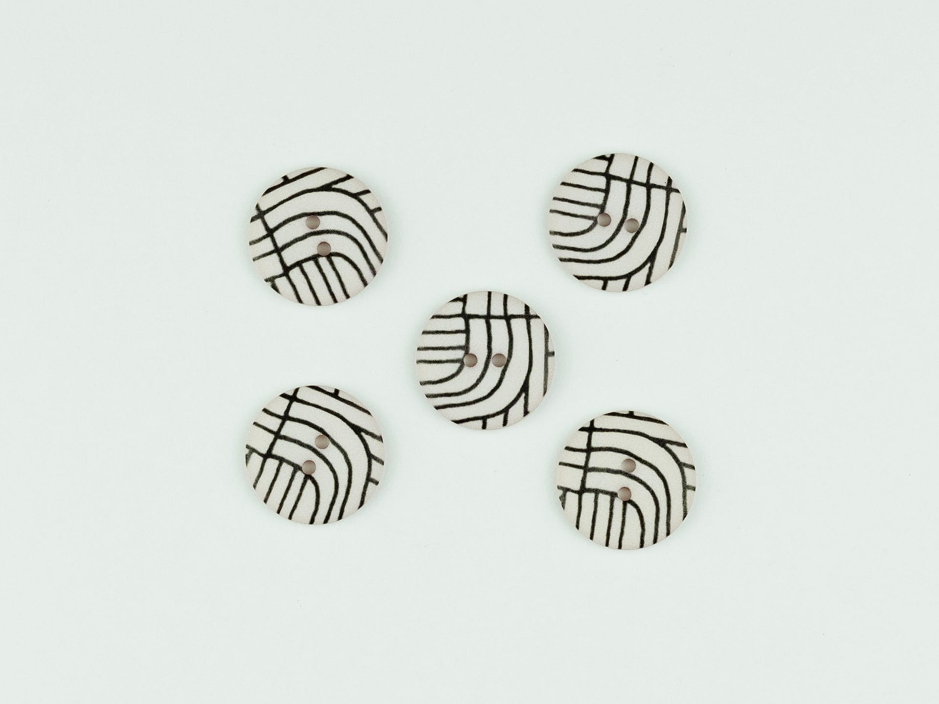 Black lines on pinky beige buttons 22mm